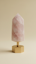 Polished rose quartz tower with brass base